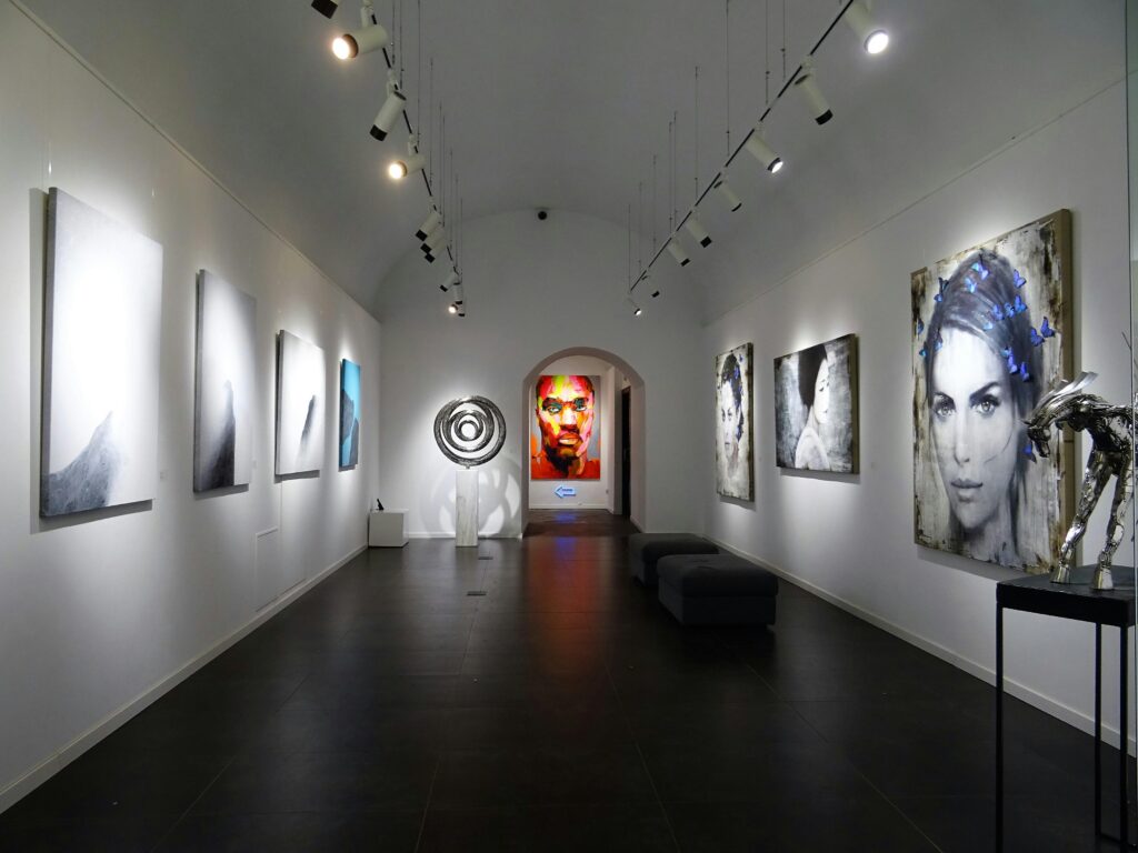 Sleek and modern art gallery with various contemporary paintings on display.