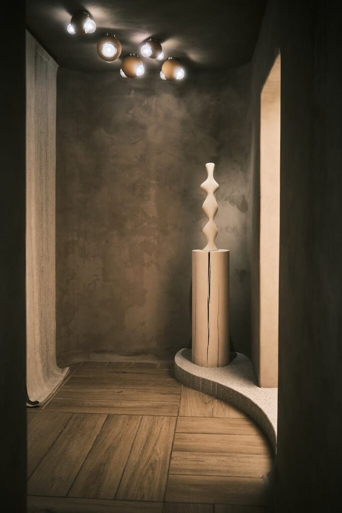 Elegant abstract clay sculpture in a minimalist urban interior captured with sophisticated lighting.