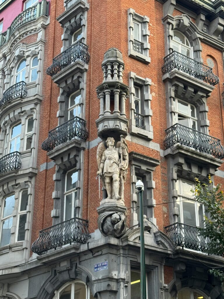 Intricate facade of a historic European building with detailed stone sculptures.